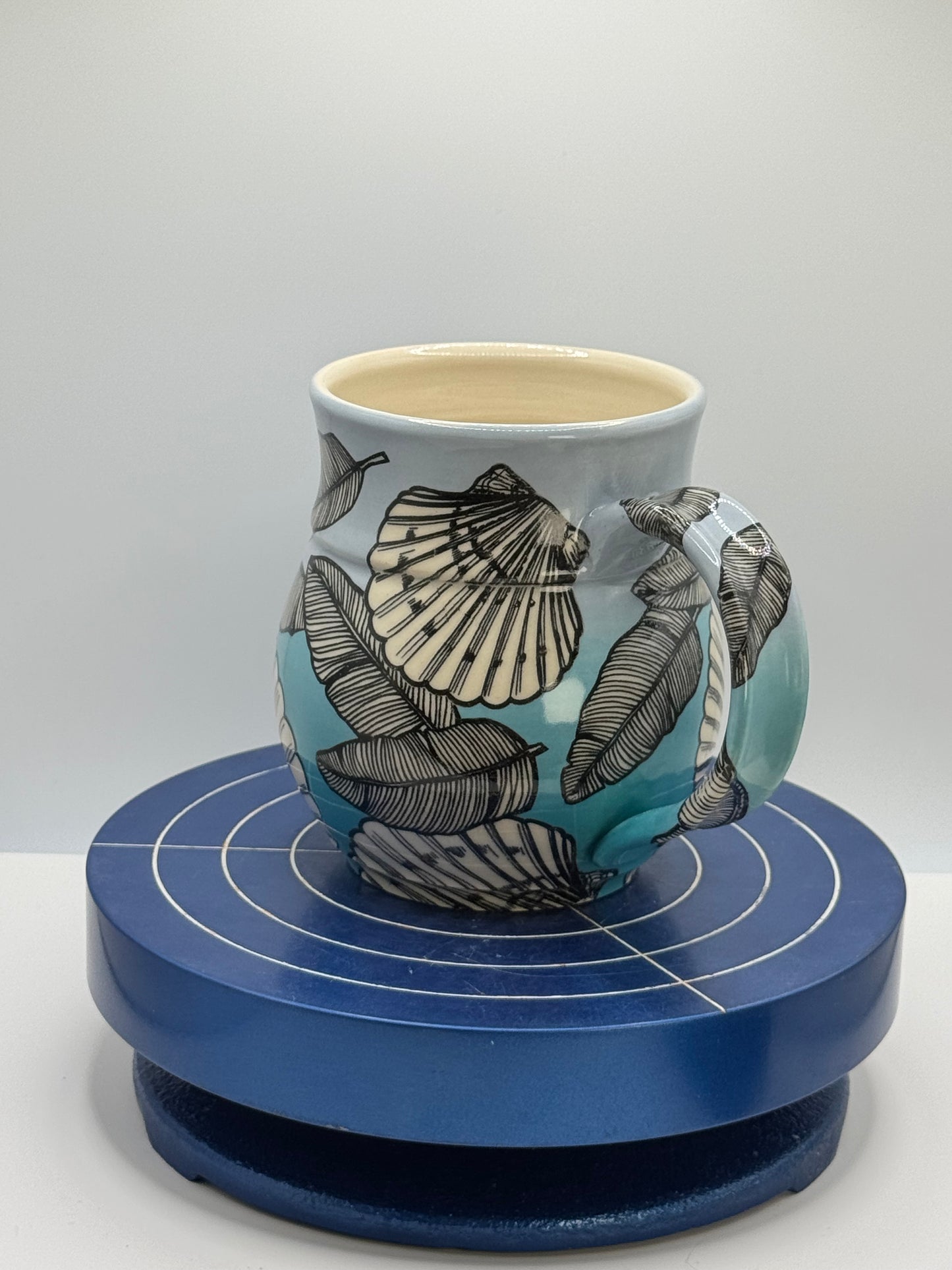 Shells and Banana Leaves in Blue Ombré Stoneware Coffee and Tea Mug